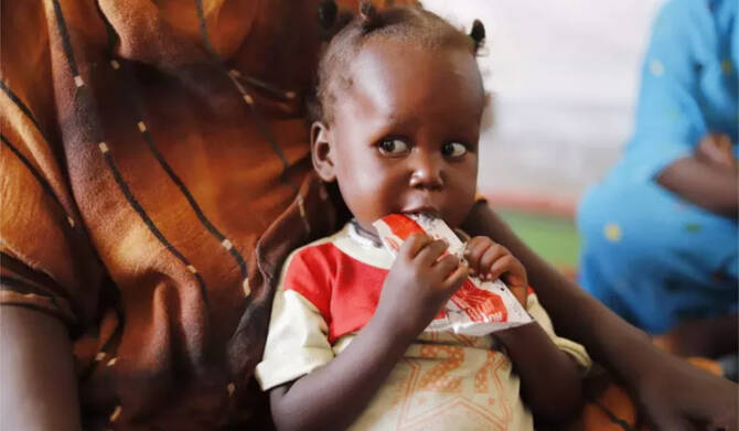 A child suffering from malnutrition eats ready-to-use food at a UNICEF-supported clinic in Tawila, North Darfur. (UNICEF)